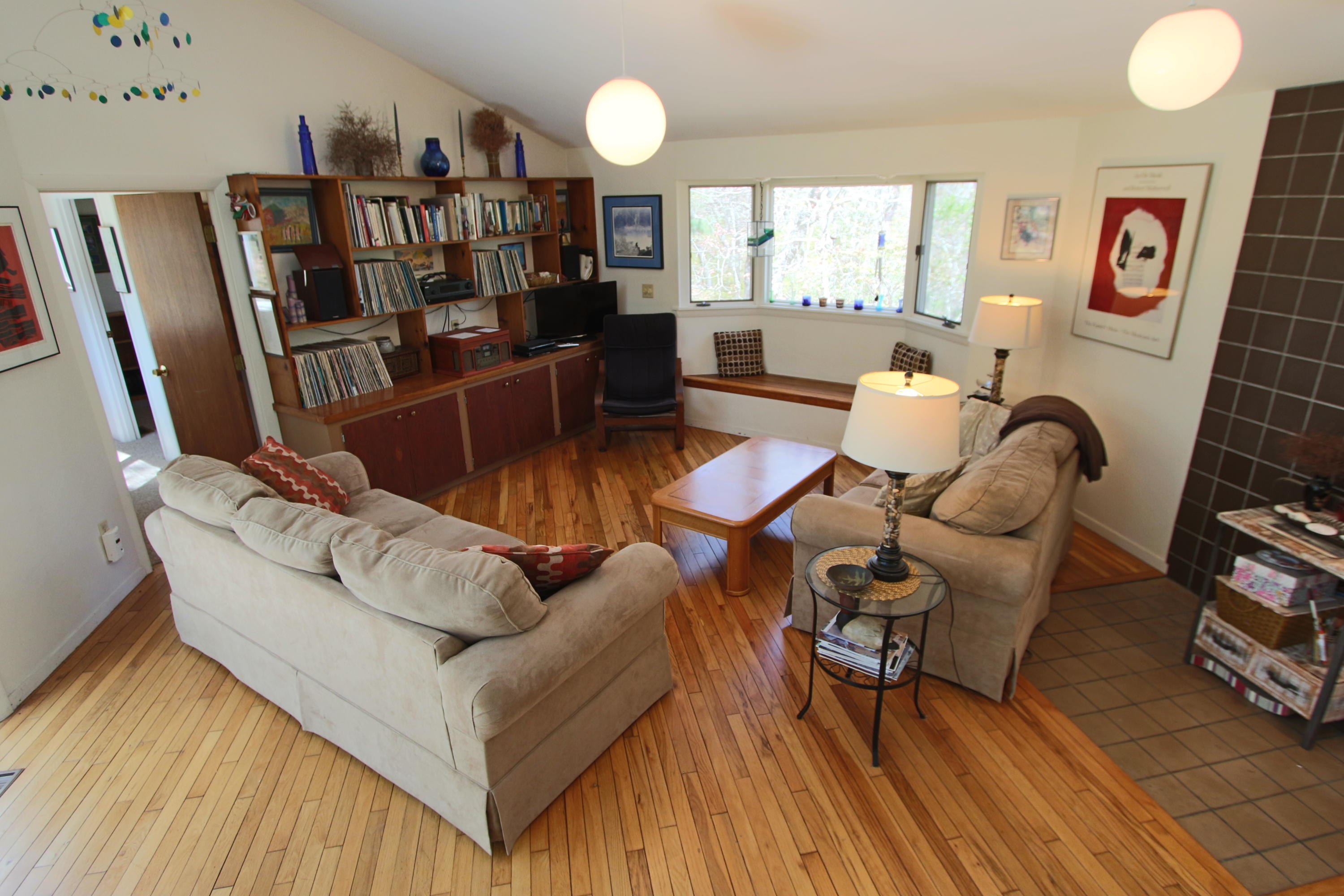5 4th Of July Road Truro, MA 02666 - Photo 4 of 33 a living room with furniture and a book shelf