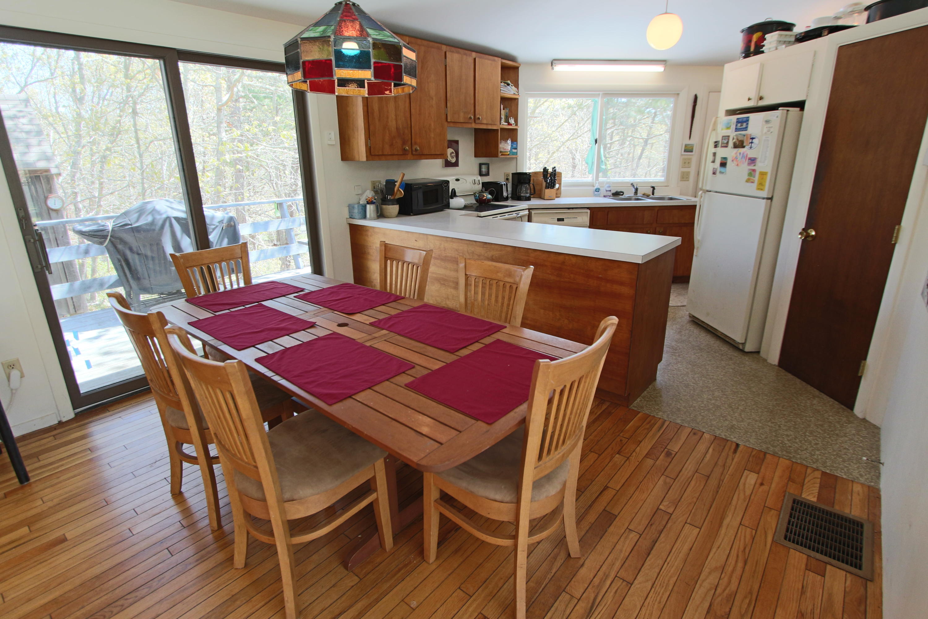 5 4th Of July Road Truro, MA 02666 - Photo 8 of 33 a dining room with furniture a window and wooden floor
