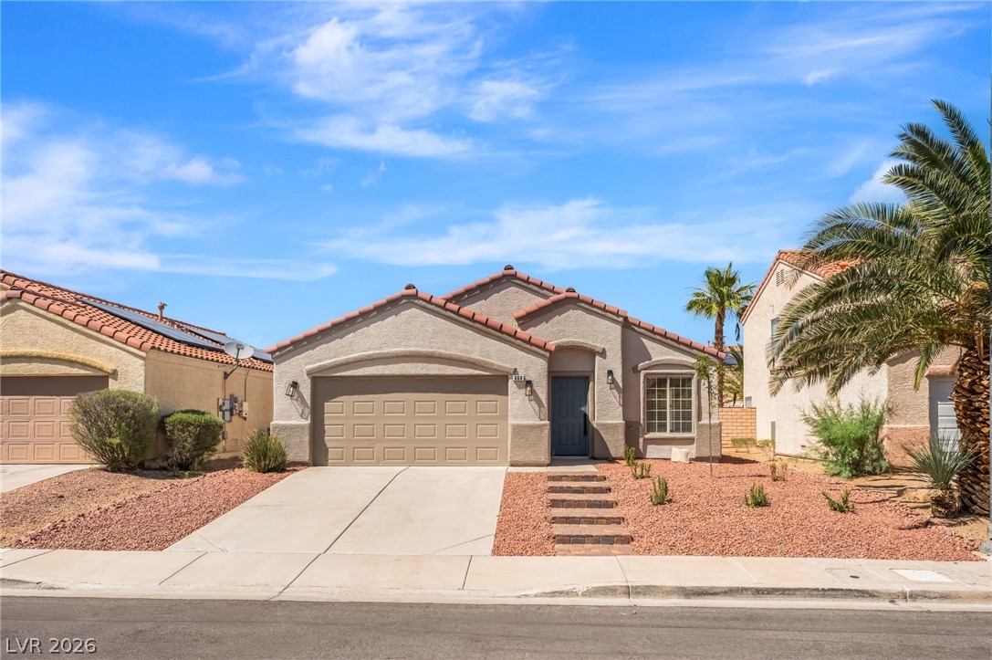 668 Rising Brook Drive Henderson, NV 89011 - Photo 1 of 22 A terracotta-tiled roof crowns this desert oasis, featuring a neat drive and a welcoming entry.