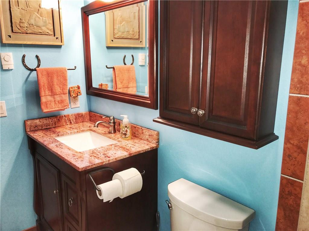 1977 Soda Ridge Road, Unit 1185 Keystone, CO 80435 - Photo 14 of 15 a bathroom with a granite countertop sink and a toilet