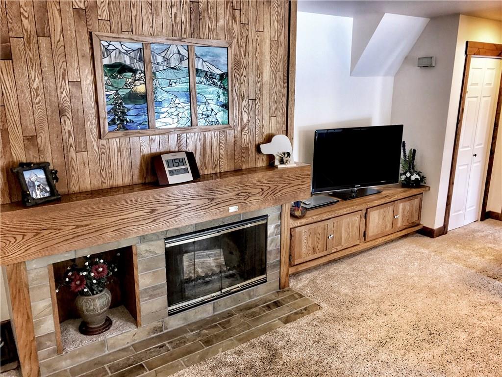 1977 Soda Ridge Road, Unit 1185 Keystone, CO 80435 - Photo 8 of 15 a living room with a flat screen tv and a fireplace