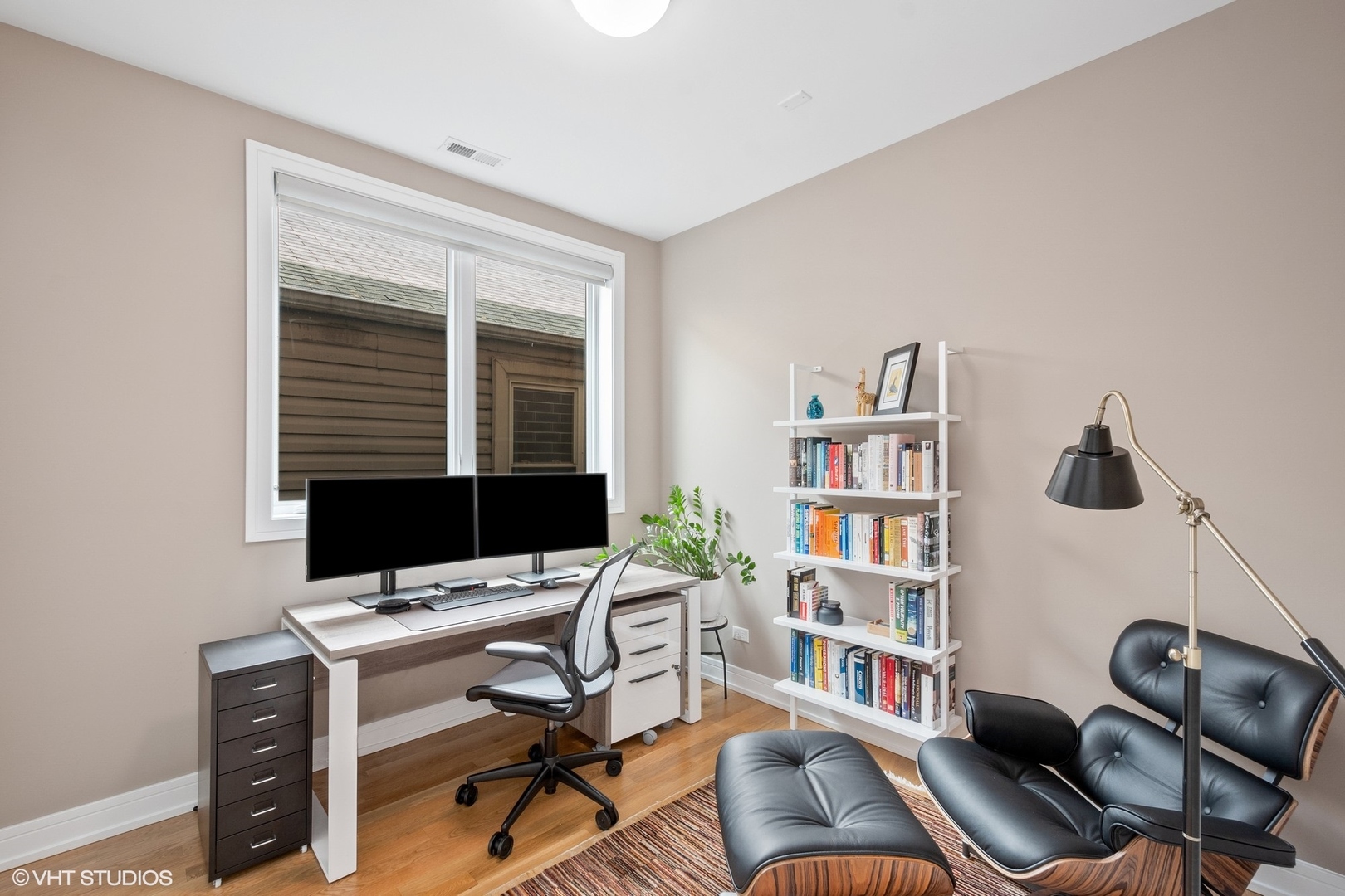 1219 North Cleaver Street, Unit 2 Chicago, IL 60642 - Photo 11 of 23 a view of a workspace with a window and lounge chair