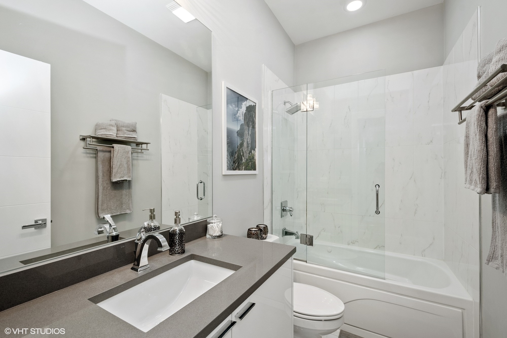 1219 North Cleaver Street, Unit 2 Chicago, IL 60642 - Photo 12 of 23 a bathroom with a granite countertop sink toilet a mirror and shower