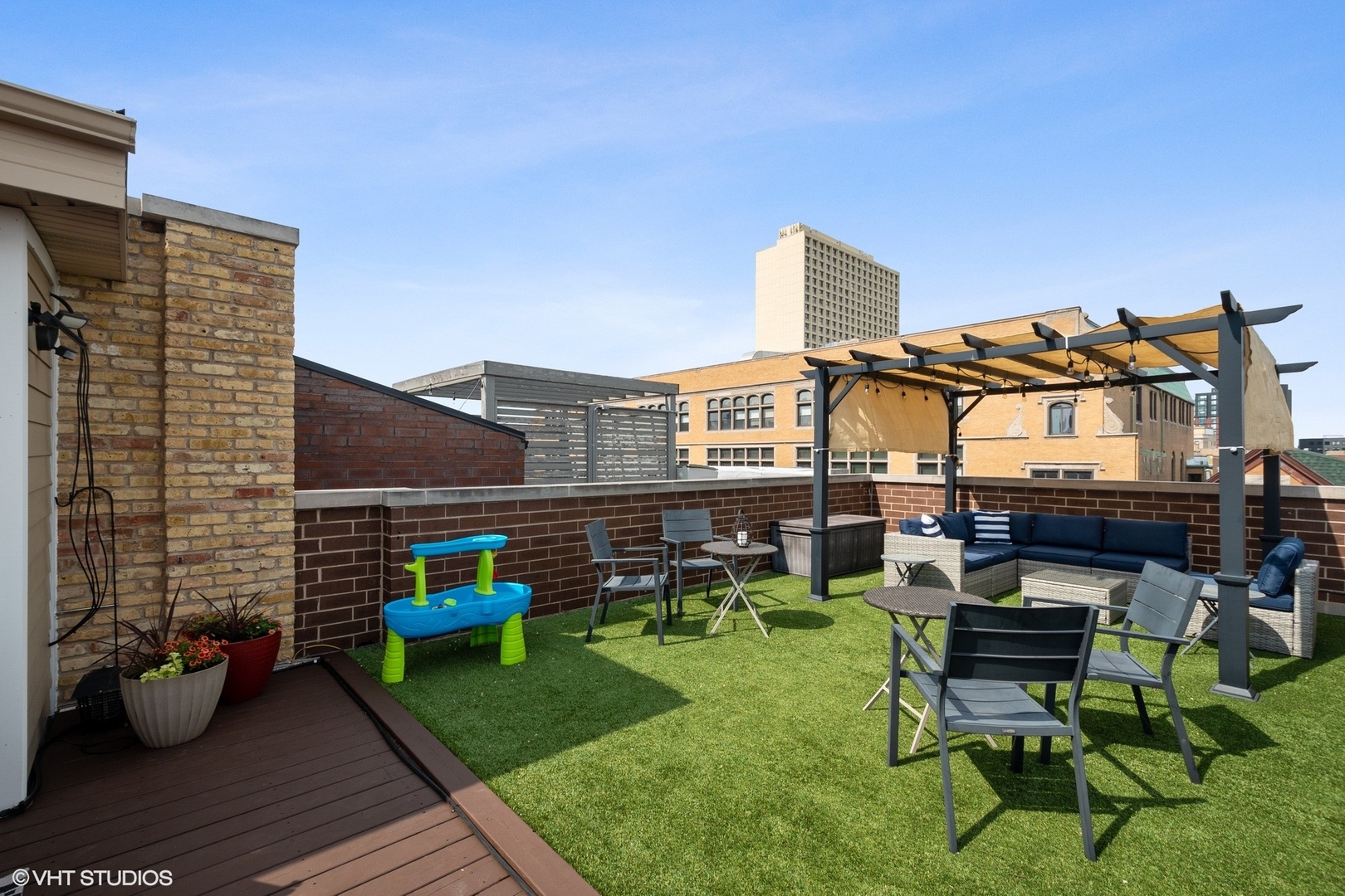 1219 North Cleaver Street, Unit 2 Chicago, IL 60642 - Photo 17 of 23 a view of a patio with couches chairs and a potted plant