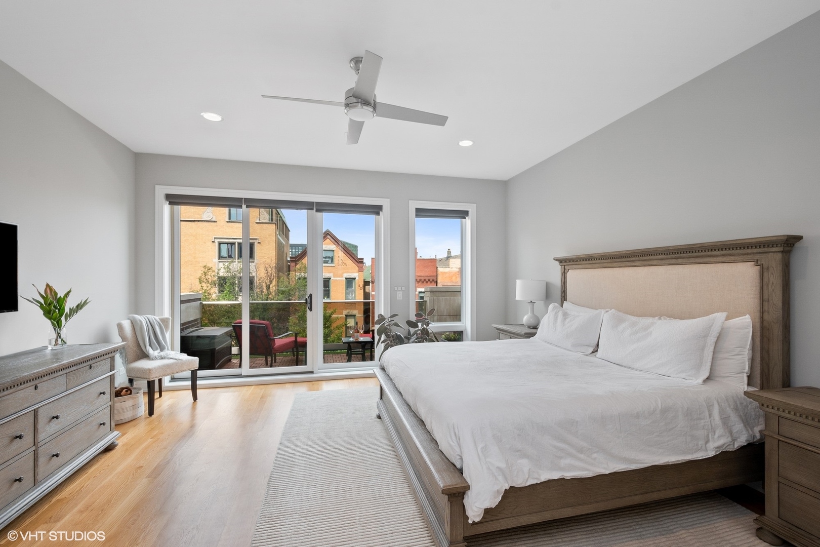 1219 North Cleaver Street, Unit 2 Chicago, IL 60642 - Photo 6 of 23 a bedroom with a large bed and a balcony view