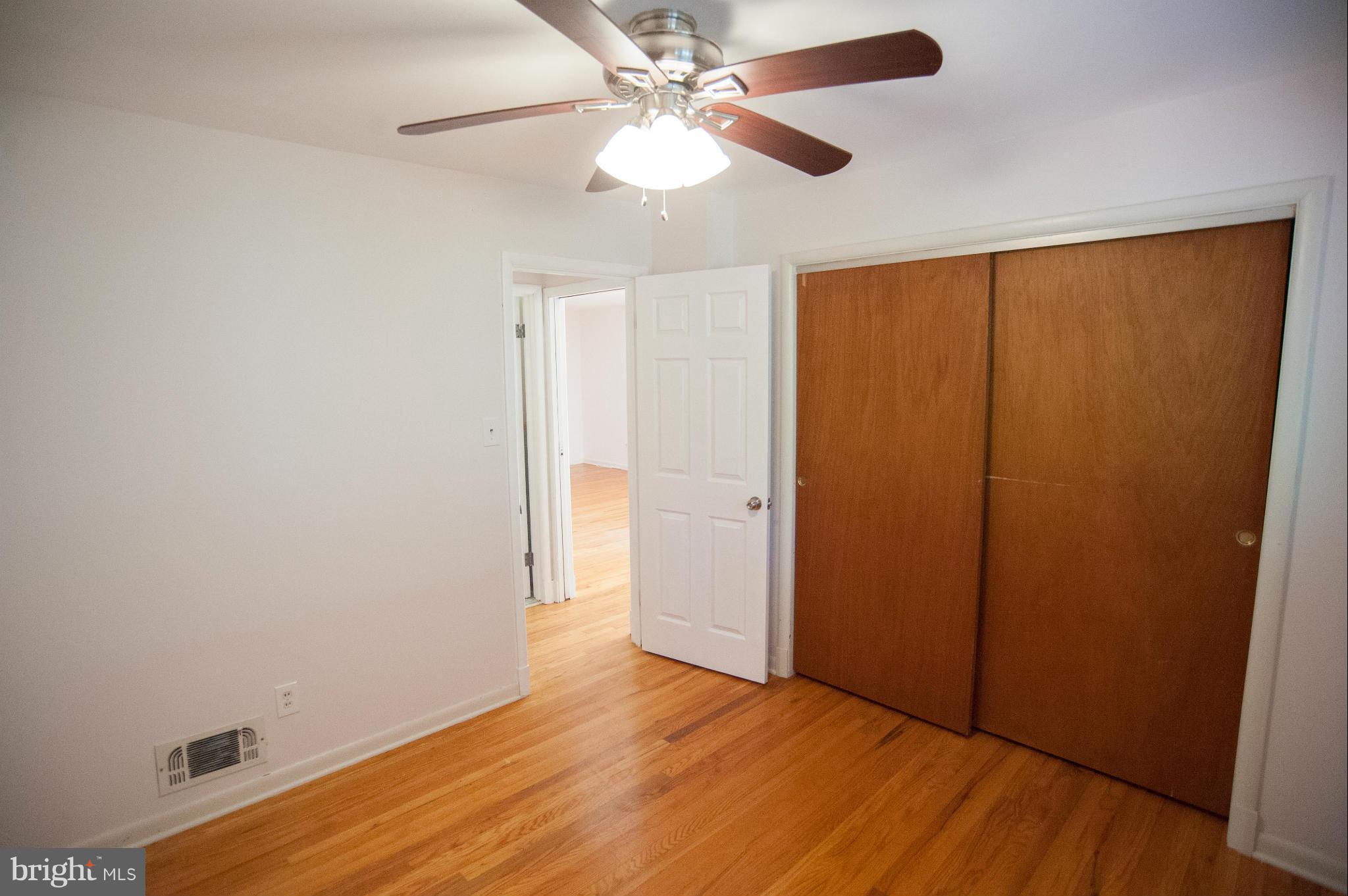 16 Goodrich Road Annapolis, MD 21401 - Photo 13 of 27 an empty room with wooden floor fan and windows