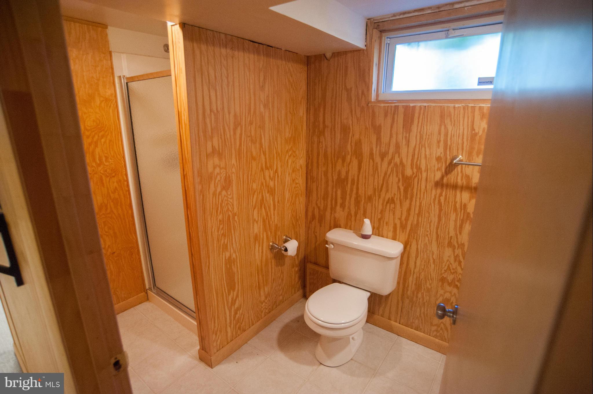 16 Goodrich Road Annapolis, MD 21401 - Photo 14 of 27 a white toilet sitting next to a shower curtain