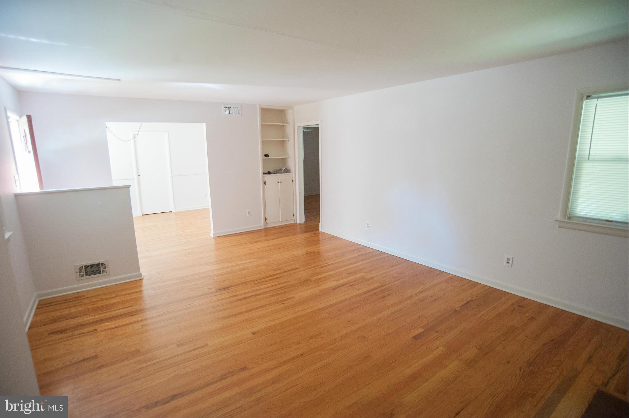 16 Goodrich Road Annapolis, MD 21401 - Photo 4 of 27 an empty room with wooden floor and windows
