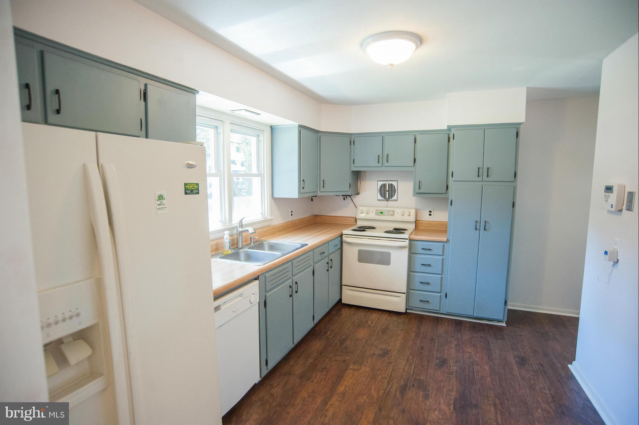16 Goodrich Road Annapolis, MD 21401 - Photo 6 of 27 a kitchen with a refrigerator a sink and dishwasher with wooden floor
