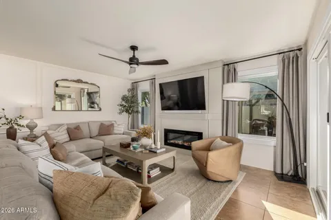 a living room with furniture a fireplace and a flat screen tv