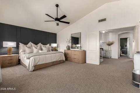 a bedroom with bed and a chandelier