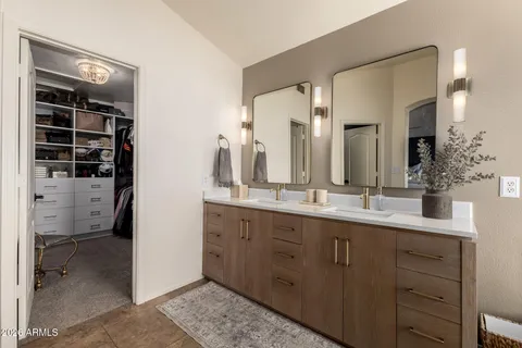a bathroom with a double vanity sink and a mirror