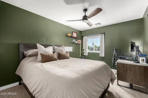 a bedroom with a large bed and a chandelier