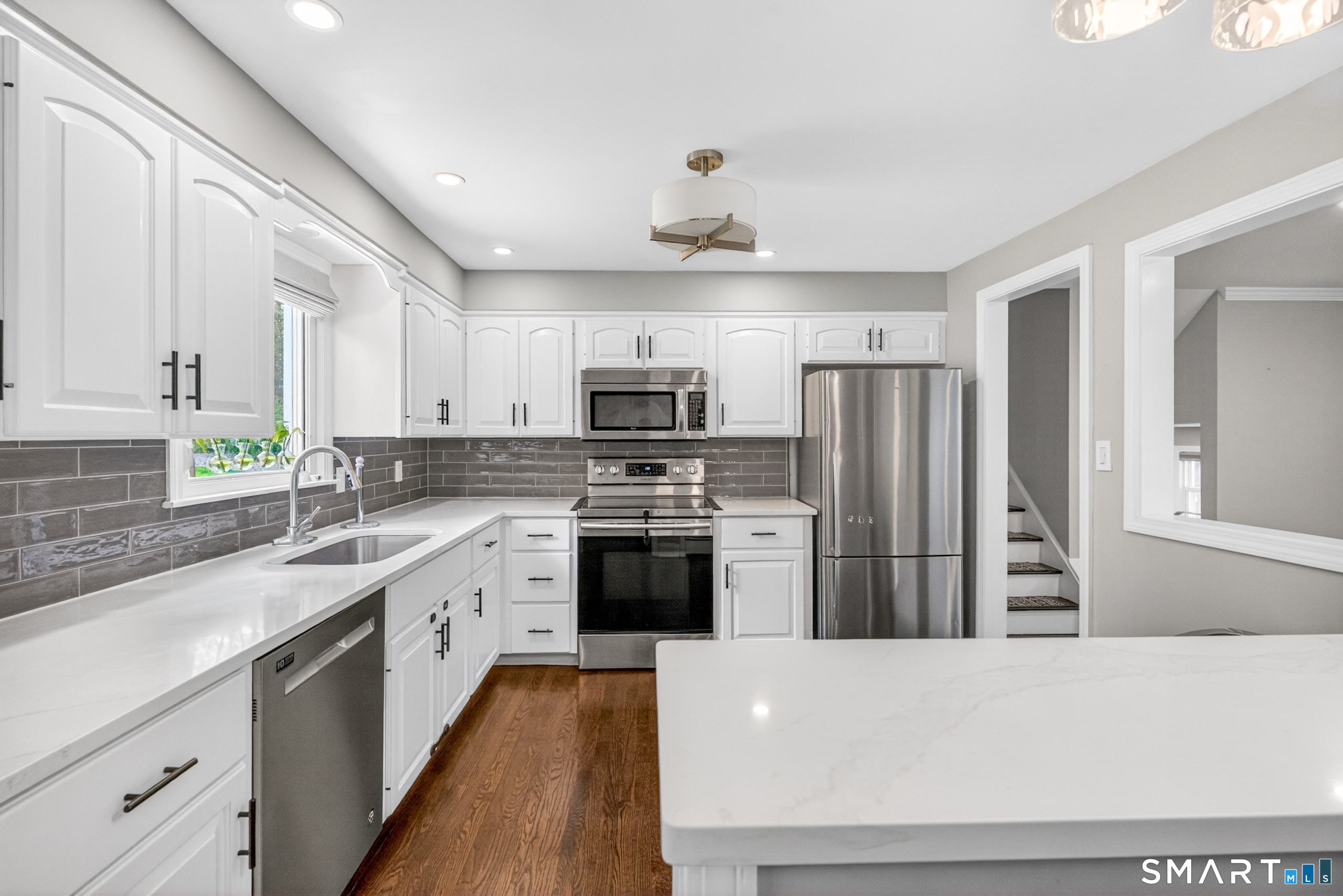 568 Wiese Road Cheshire, CT 06410 - Photo 14 of 40 a kitchen with refrigerator a sink and wooden cabinets