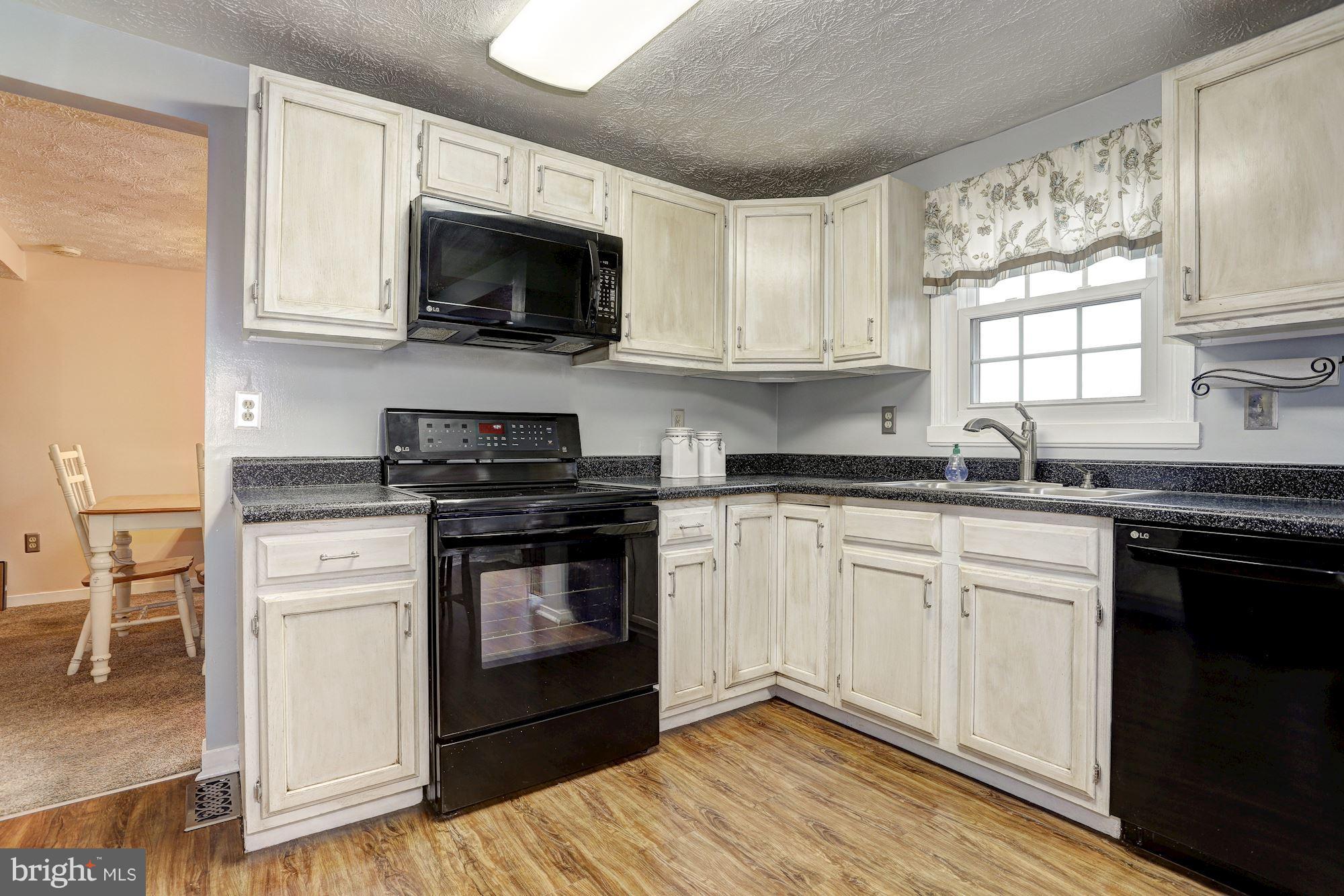 11 Class Court Baltimore, MD 21234 - Photo 11 of 25 a kitchen with granite countertop a sink cabinets and stainless steel appliances