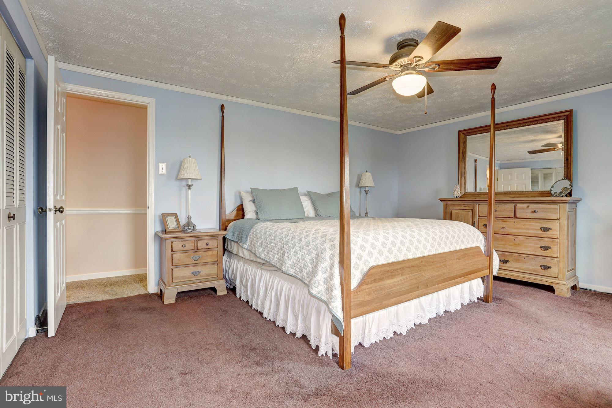 11 Class Court Baltimore, MD 21234 - Photo 13 of 25 a bedroom with a bed chandelier and dresser