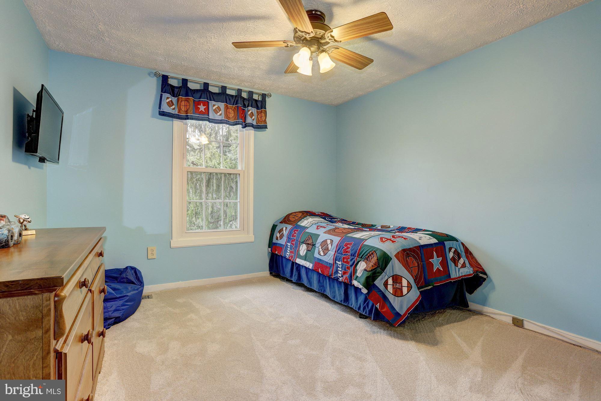11 Class Court Baltimore, MD 21234 - Photo 16 of 25 a bedroom with a bed and a chandelier