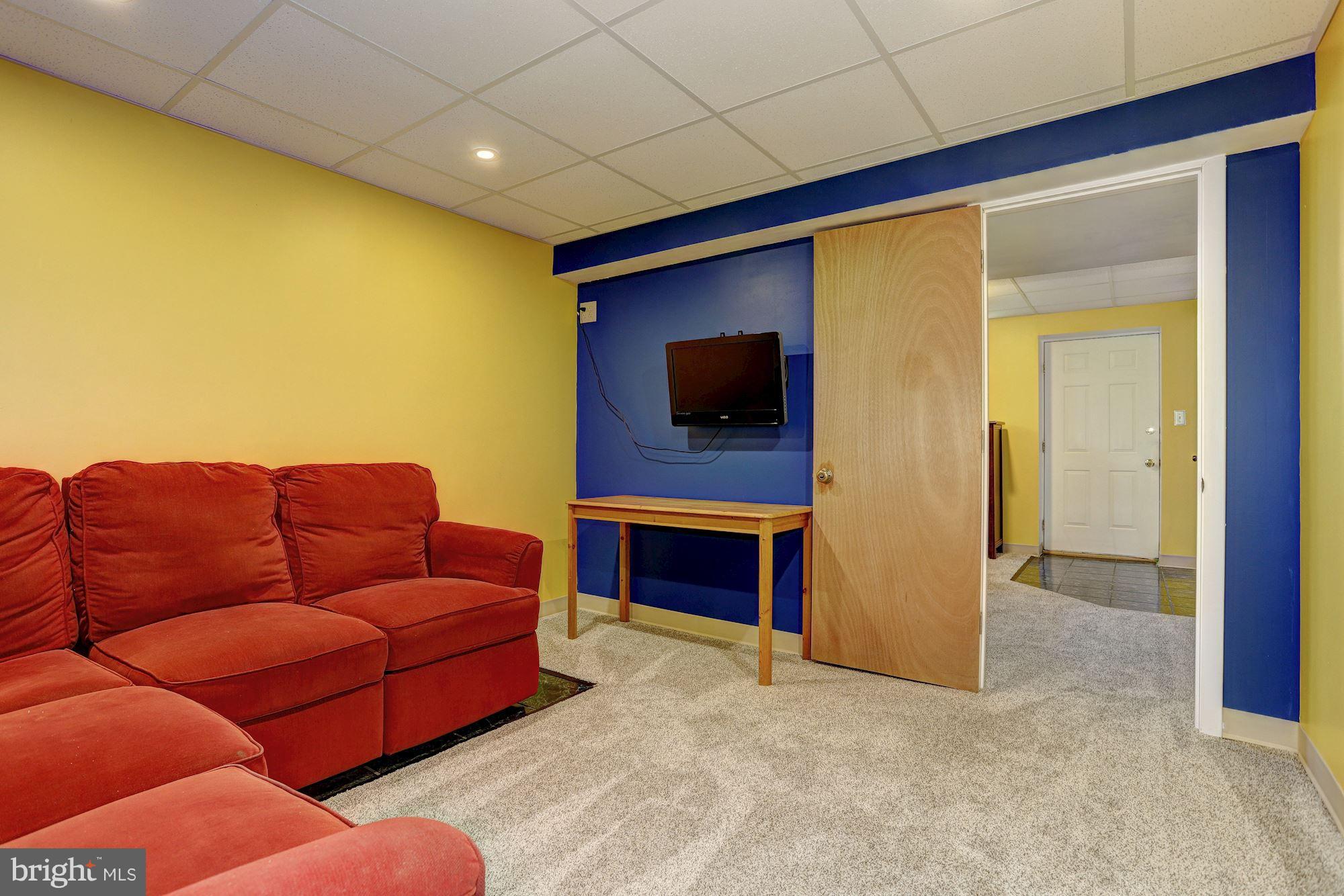 11 Class Court Baltimore, MD 21234 - Photo 21 of 25 a living room with furniture a flat screen tv and a fireplace