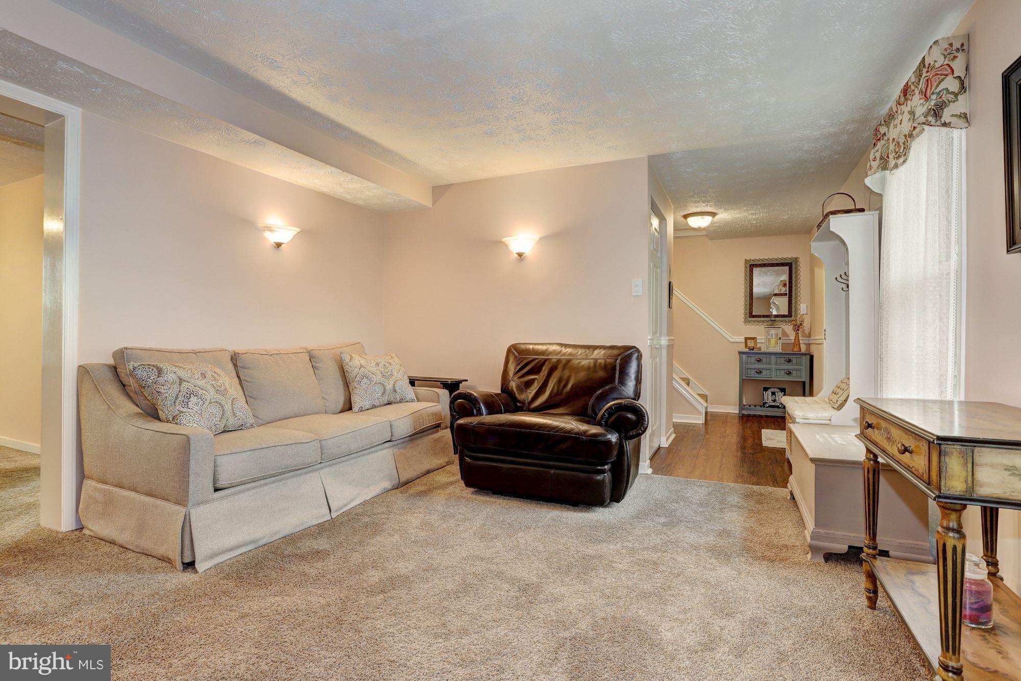 11 Class Court Baltimore, MD 21234 - Photo 5 of 25 a living room with furniture and a chandelier