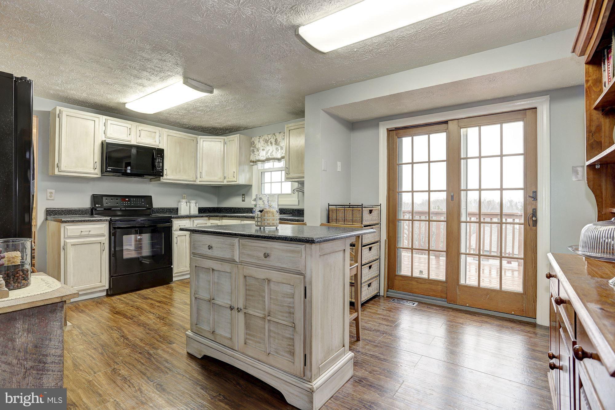 11 Class Court Baltimore, MD 21234 - Photo 8 of 25 a kitchen with stainless steel appliances granite countertop a stove top oven a sink a dining table and chairs