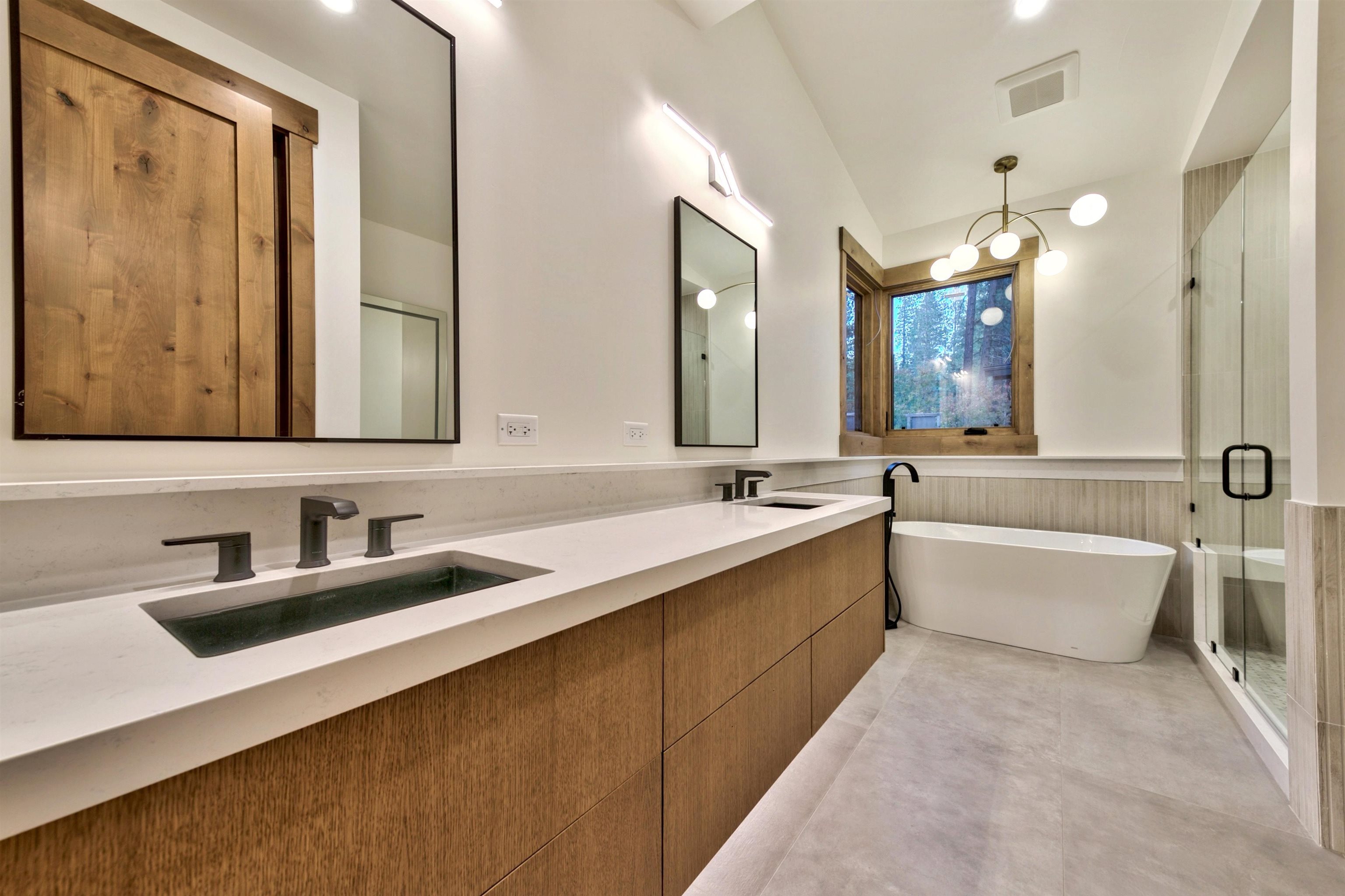 11620 Ghirard Road Truckee, CA 96161 - Photo 16 of 21 a bathroom with a bathtub a double vanity sink and mirror
