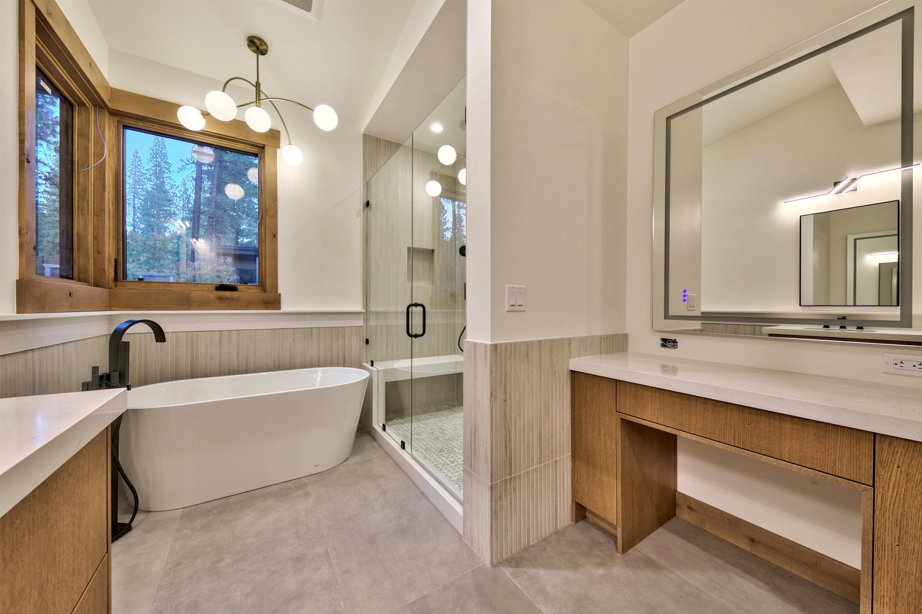 11620 Ghirard Road Truckee, CA 96161 - Photo 17 of 21 a bathroom with a tub a double vanity sink and mirror