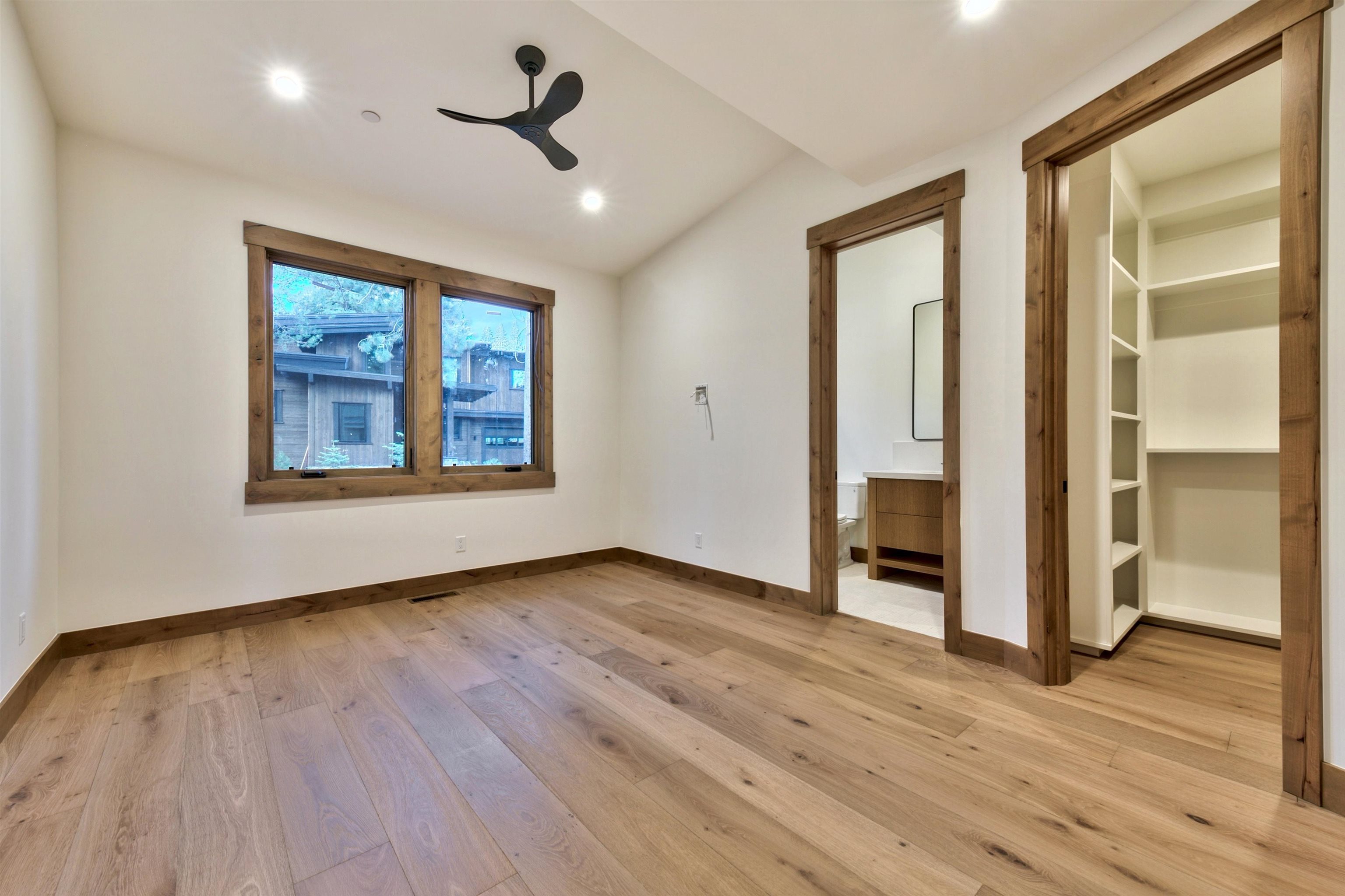 11620 Ghirard Road Truckee, CA 96161 - Photo 18 of 21 an empty room with wooden floor and windows