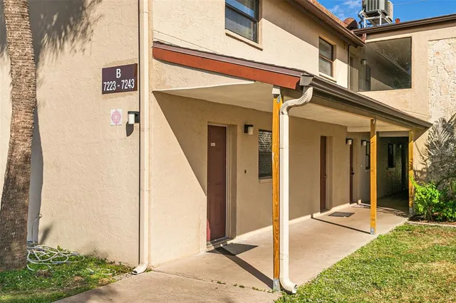 a view of a porch with a table and chairs and potted plants