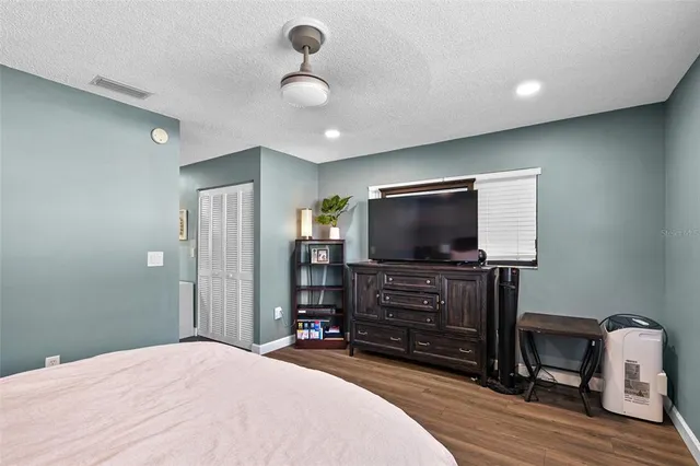 a bedroom with furniture and flat screen tv