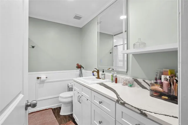 a bathroom with a double vanity sink mirror and toilet