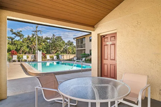 a view of a patio with table and chairs potted plants with wooden floor