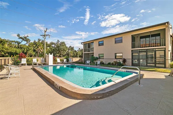 a swimming pool with outdoor seating and yard