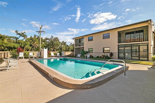 a swimming pool with outdoor seating and yard