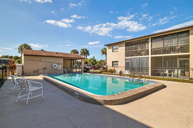 a view of a house with swimming pool and sitting area