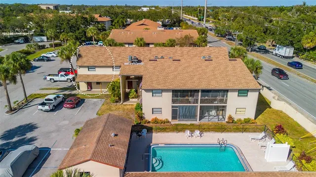 an aerial view of a house with a swimming pool patio and outdoor seating