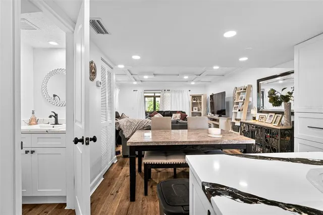 a view of a kitchen with kitchen island a table and chairs