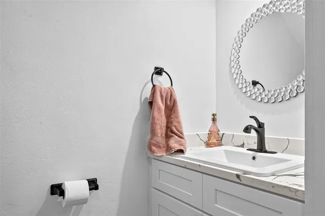 a bathroom with a sink and mirror
