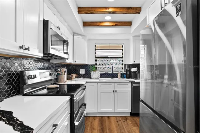 a kitchen with a sink a stove and cabinets