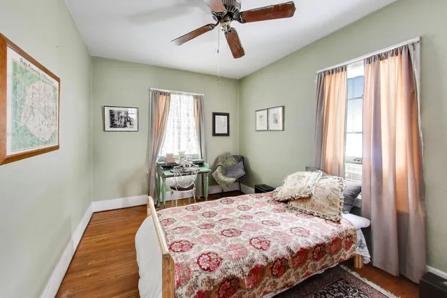 a bedroom with a bed and wooden floor