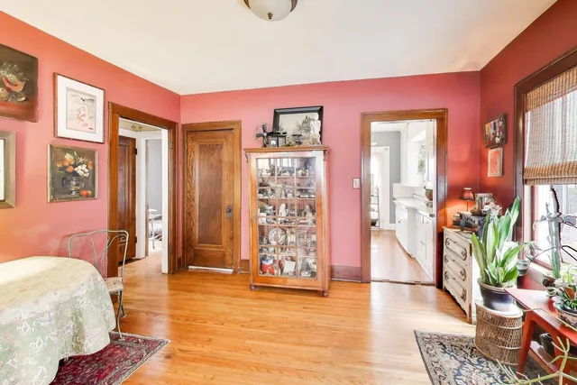 a spacious bedroom with a bed and wooden floor