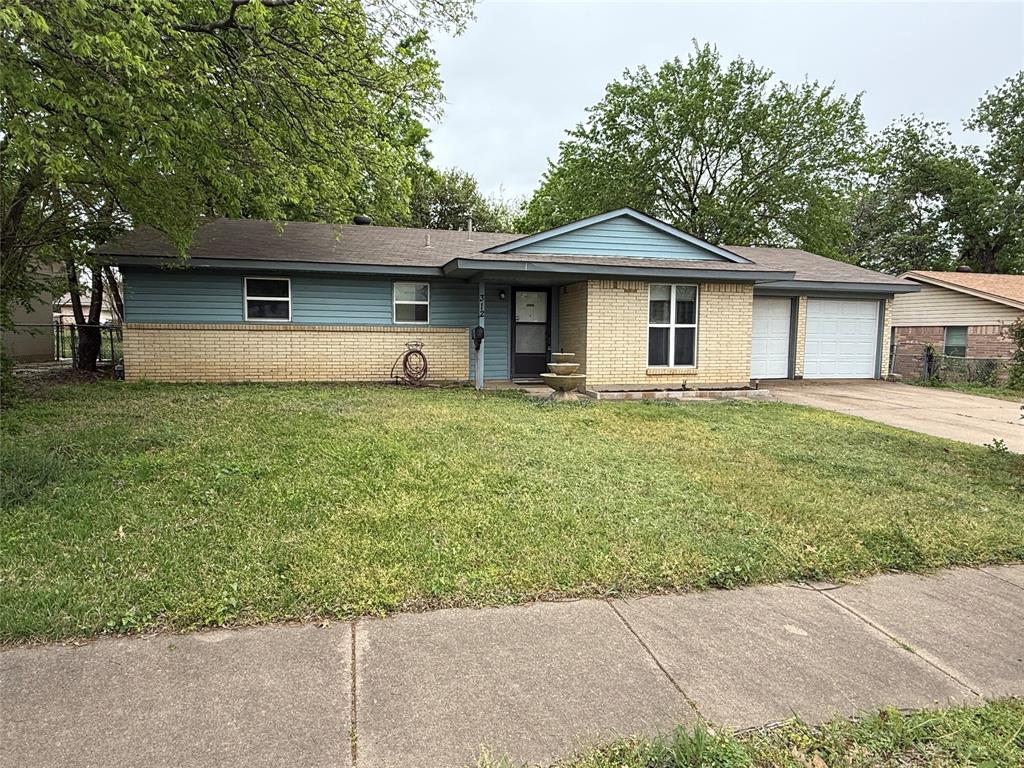 312 East Fuller Drive Euless, TX 76039 - Photo 1 of 1 a front view of a house with a yard and garage