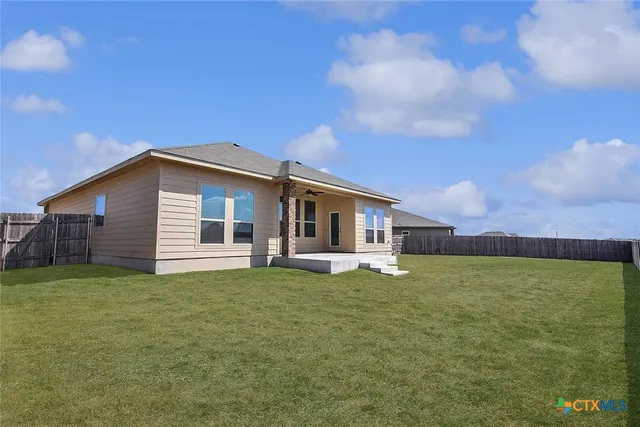 a big house with a big yard and large trees