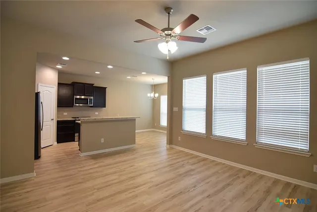 a view of kitchen with sink and wooden floor