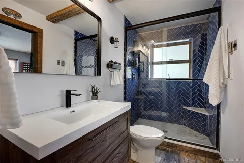 a bathroom with a sink toilet and shower