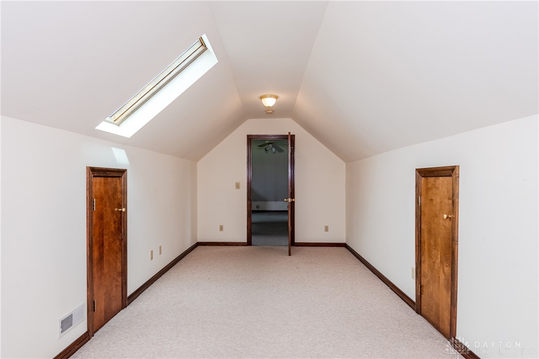 9981 Ridge Acres Lane Englewood, OH 45322 - Photo 40 of 73 This spacious room features vaulted ceilings, a skylight, and soft carpeting.