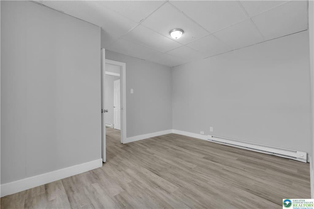 149 West Ridge Street, Unit 3A Lansford, PA 18232 - Photo 4 of 6 A versatile finished lower level room features durable wood-look flooring and clean baseboard heating.