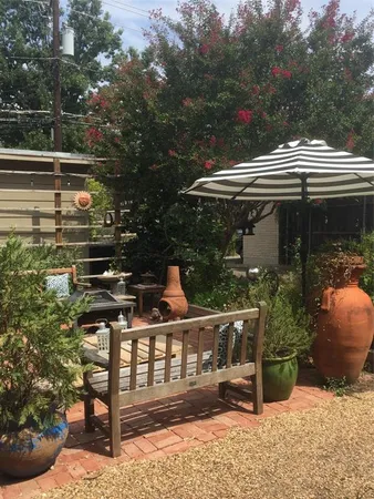 a view of deck with a table and chairs under an umbrella