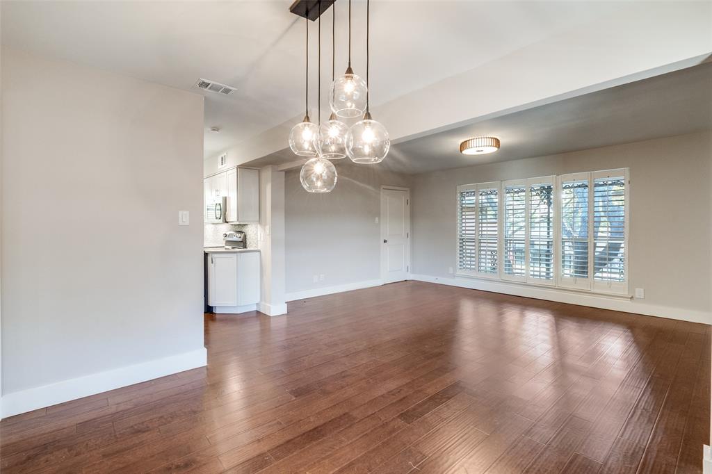 6159 Bandera Avenue Dallas, TX 75225 - Photo 2 of 13 a view of an empty room with wooden floor and a window