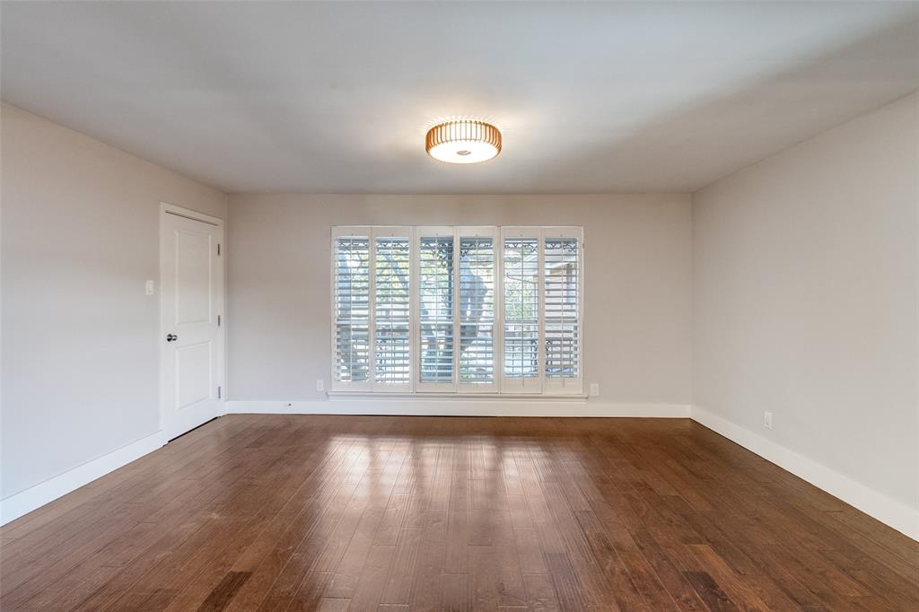 6159 Bandera Avenue Dallas, TX 75225 - Photo 3 of 13 a view of an empty room with wooden floor and a window