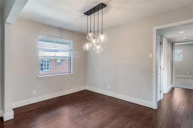 a view of a room with wooden floor chandelier and entryway